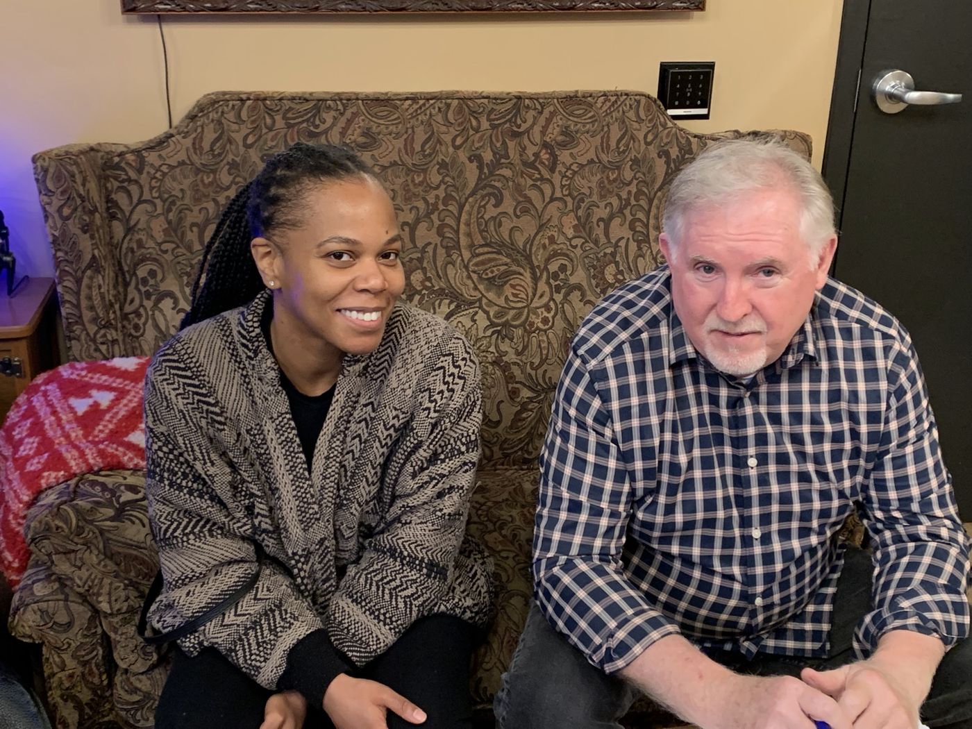 A Blue Heron Records artist and founder Joe LeDuc sitting together on the studio couch, smiling.