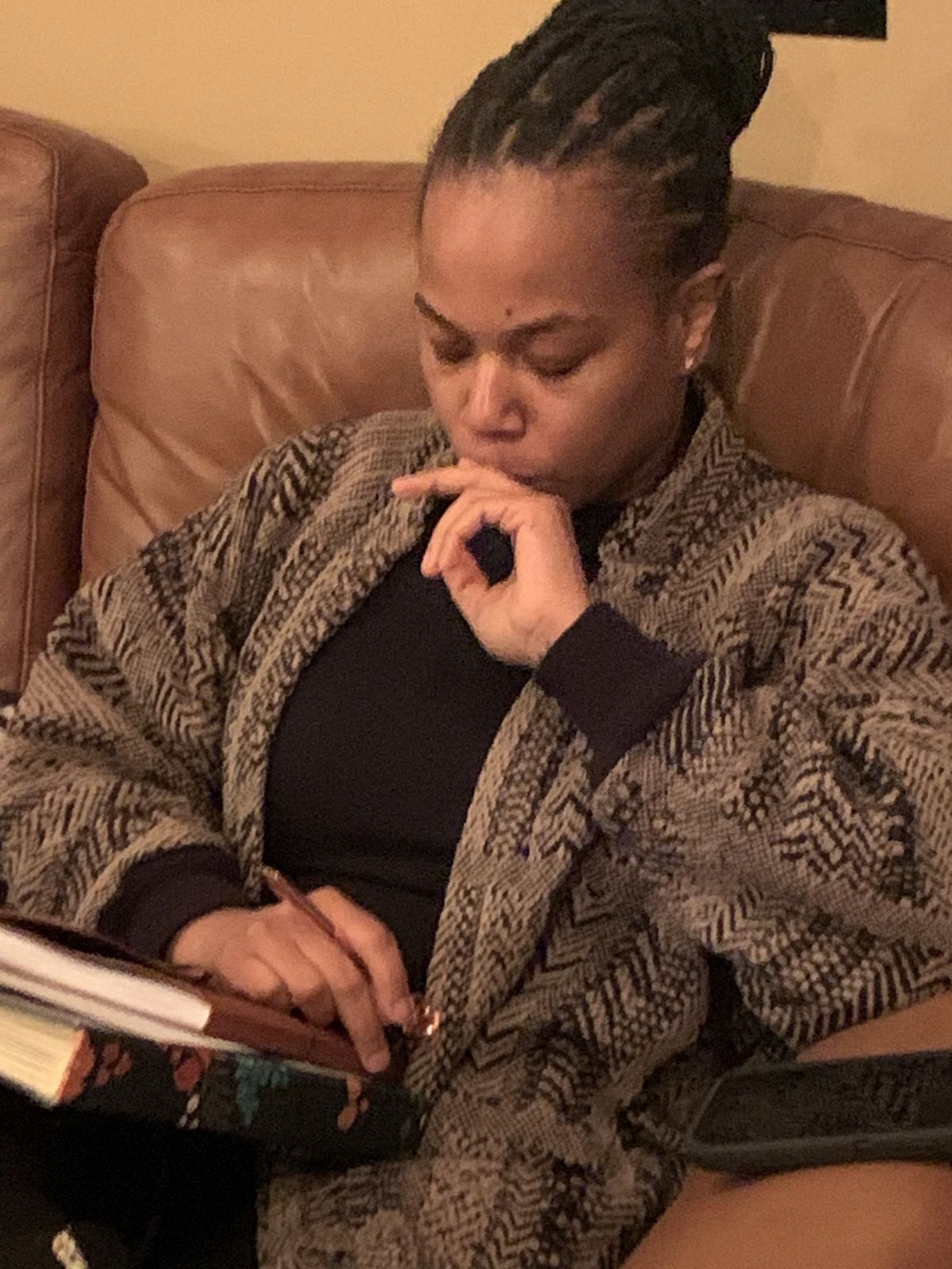 A vocalist with a notebook, focused.